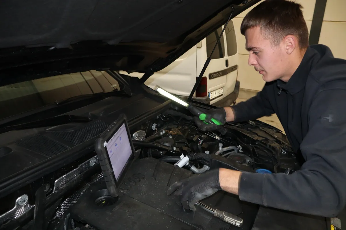 Monteur van Mos-Automotive leest een wagen uit met diagnoseapparatuur